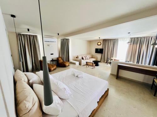 a bedroom with a bed and a living room at Gioma Garden Villas in Istron