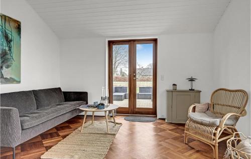 a living room with a couch and a table at Nice Home In Ebeltoft With Wifi in Ebeltoft