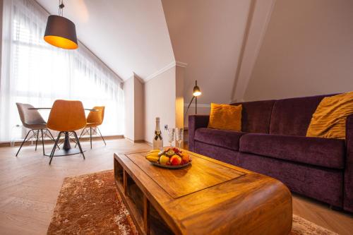 a living room with a couch and a table at Penzion MartInn in Martin