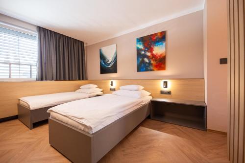 a hotel room with two beds and a window at Penzion MartInn in Martin
