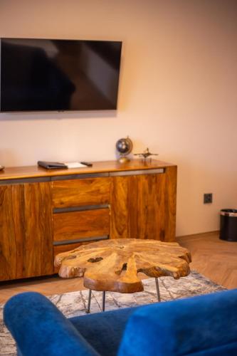 a living room with a wooden dresser with a tv on it at Penzion MartInn in Martin