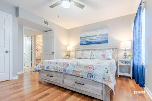 a bedroom with a bed in a room with wood floors at Hidden Gem - pool access, walk to beach in Destin