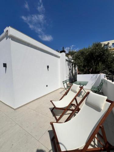 a group of chairs and a table on a patio at Gioma Garden Villas in Istron