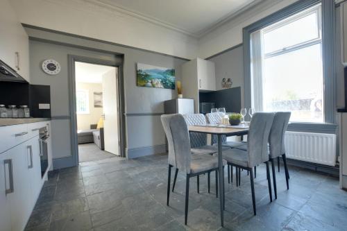 a kitchen and dining room with a table and chairs at Winwood House in Goole