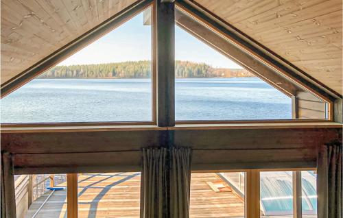 a large window in a house with a view of a lake at Amazing Home In Dalsjöfors With Sauna in Dalsjöfors