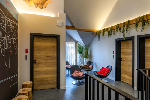 a hallway with chairs and tables in a room at Loox Ostrovo- Boutique House-noclegi nad morzem in Ostrowo
