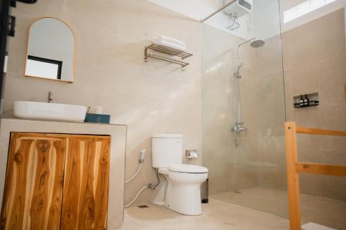 a bathroom with a toilet and a sink and a shower at Gisela Villa With Private Pool in Buleleng