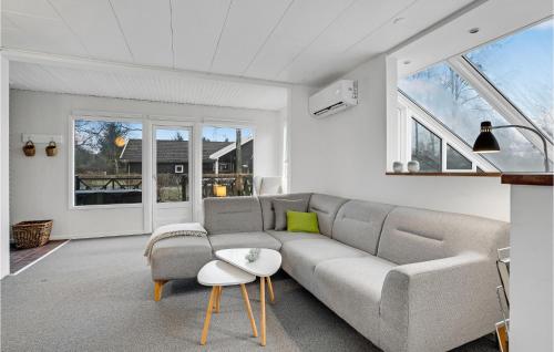 a living room with a couch and some windows at Stunning Home In Fårvang With Wifi in Fårvang
