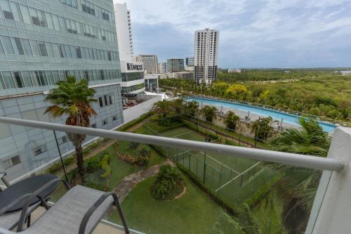 a view from the balcony of a building with a pool at Ocean Breeze, Cancun Sanctuary - HiveNB in Cancún