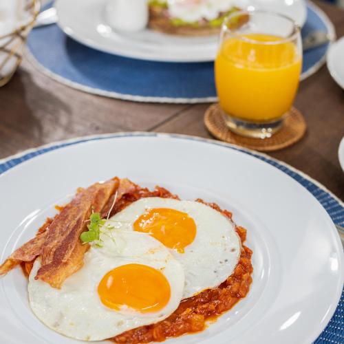 a plate of food with eggs on a table at Casa La Merced by Mustique in Cartagena de Indias