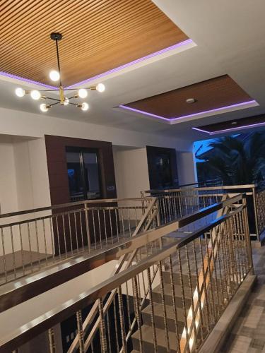 a lobby with a ceiling fan and a staircase at MGM Guest House in San Felix