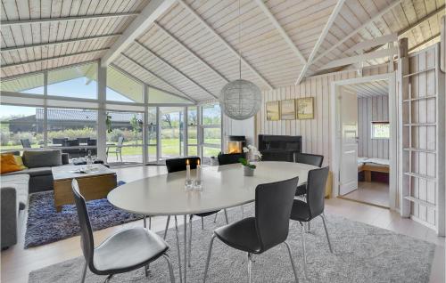 a dining room and living room with a table and chairs at Gorgeous Home In Ejstrupholm With Sauna in Ejstrupholm