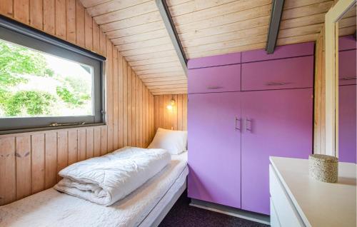 a small room with a bed and a window at Holiday Home Silkeborg With A Fireplace 05 in Funder Kirkeby