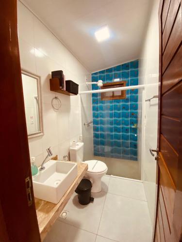 a bathroom with a sink and a toilet and a shower at Pontal dos Sonhos- Chalés Praia do Farol in Coruripe