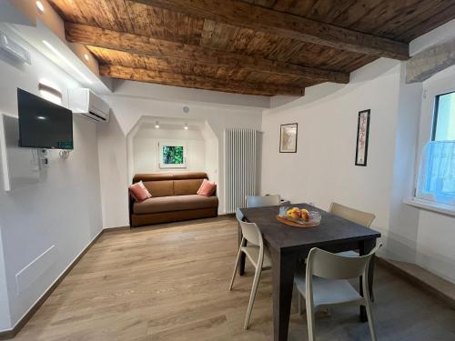 a living room with a table and a couch at Residenza Alice in Arco