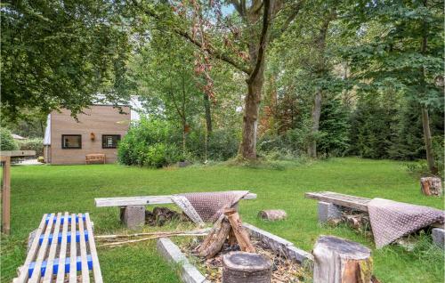 a picnic table and benches in a yard at Cozy Home In Bjerringbro With Wifi in Bjerringbro