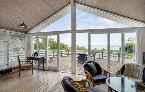 a living room with a view of a deck at Amazing Home In Broager With Kitchen in Broager