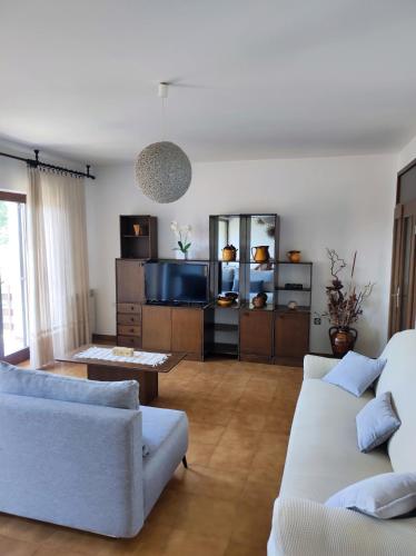 a living room with two couches and a tv at Apartment Luno in Zvoneće