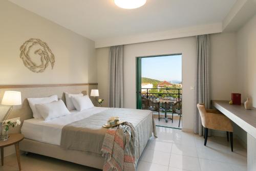a hotel room with a bed and a balcony at Sivota Hotel in Sivota