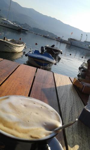 a table with a bowl and boats in the water at Apartmani Vila Marija in Budva