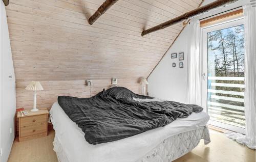 a large bed in a room with a window at Amazing Home In Rønne With Kitchen in Rønne