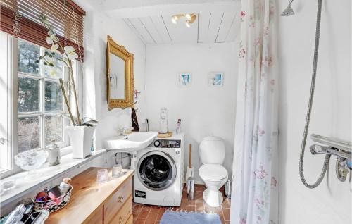 a bathroom with a washing machine and a sink at Amazing Home In Rønne With Kitchen in Rønne