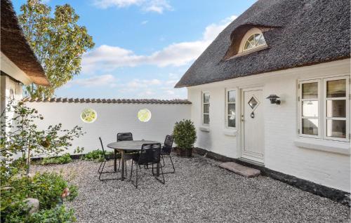 a patio with a table and chairs in front of a house at Awesome Home In Sydals With Wifi in Ertebjerg