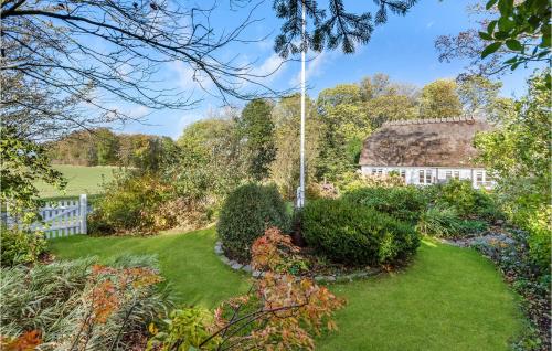 a garden with a white fence and a building at Awesome Home In Sydals With Wifi in Ertebjerg