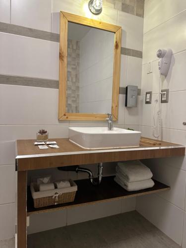 a bathroom with a sink and a mirror at CASA CRISTOBAL Centenario in Cusco