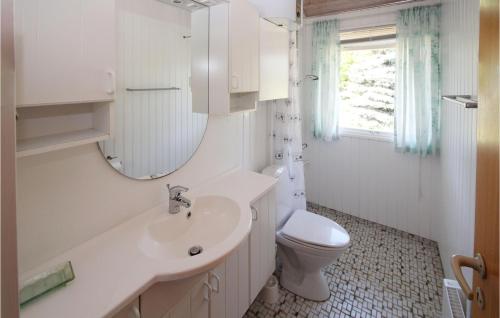 a white bathroom with a sink and a toilet at Nice Home In Samsø With Kitchen in Onsbjerg