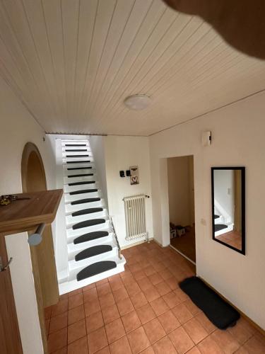 a room with a staircase in a house at Gästezimmer,Monteurzimmer & Pension Eda in Winsen Aller