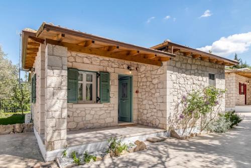 a stone house with a green door at Apanema Mindfulness Resort Lefkada - ultra fast Starlink WiFi in 2025 in Asprogerakata