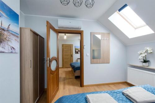 a bedroom with a bed and a skylight at Wiślany Zakątek in Gdańsk