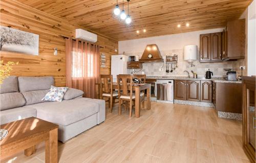a living room with a couch and a kitchen at 2 Bedroom Amazing Home In Rute in Rute