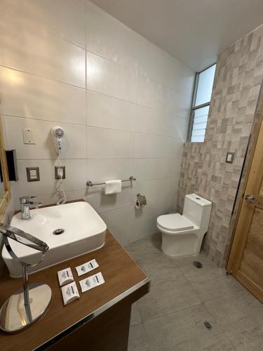 a bathroom with a sink and a toilet at CASA CRISTOBAL Centenario in Cusco