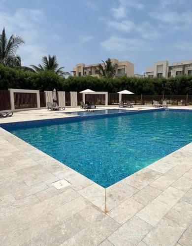 a large swimming pool with blue water at منتجع هوانا in Salalah