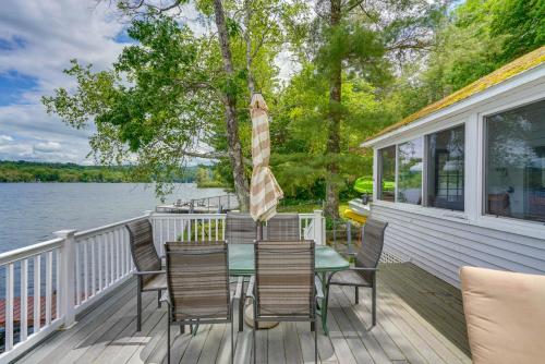 a deck with a table and chairs on a house at Massachusetts Lake House with Dock - Pets Welcome! in New Marlborough