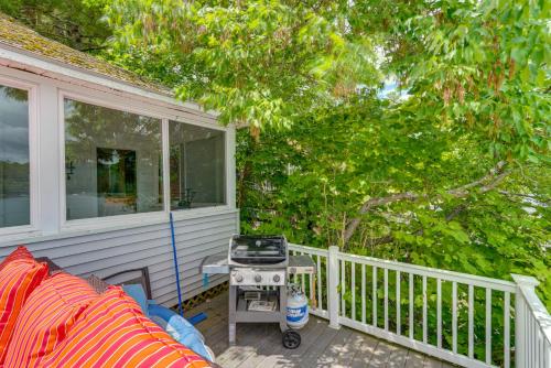 a porch with a grill and a chair on a house at Massachusetts Lake House with Dock - Pets Welcome! in New Marlborough