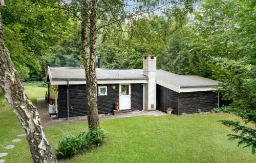 a cabin in the woods with a yard at Nice Home In Frederiksværk With Wifi in Frederiksværk
