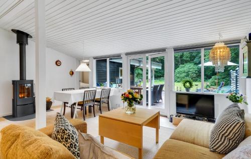 a living room with a couch and a table at Nice Home In Frederiksværk With Wifi in Frederiksværk