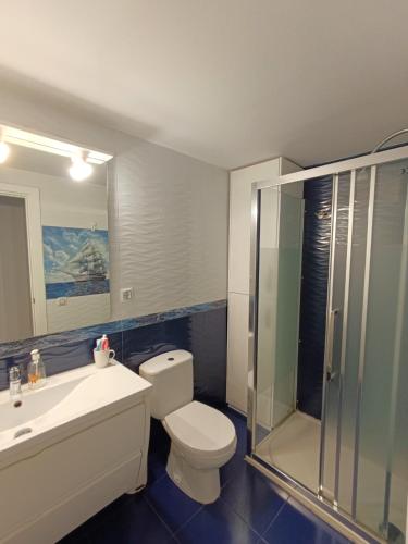 a bathroom with a toilet and a sink and a shower at Costa Brazil Sunset Apartment in Benicàssim