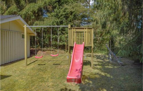 a playground with a red slide and a swing at Three-Bedroom Holiday Home In Ans By in Roe