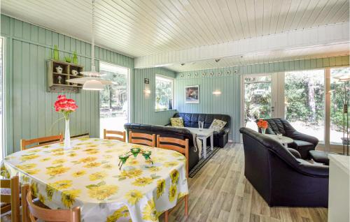 a dining room with a table and a living room at Three-Bedroom Holiday Home In Ans By in Roe