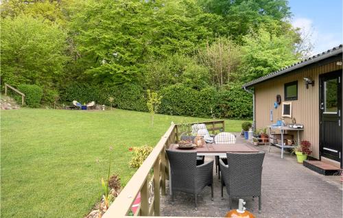 a patio with a table and chairs in a yard at Beautiful Home In Haarby With Kitchen in Brunshuse