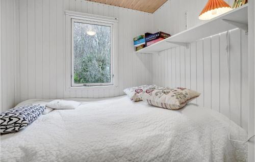 a white bedroom with a bed and a window at Beautiful Home In Haarby With Kitchen in Brunshuse