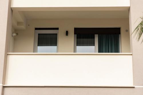 a building with two windows and a fence at Bagheria Home in Bagheria