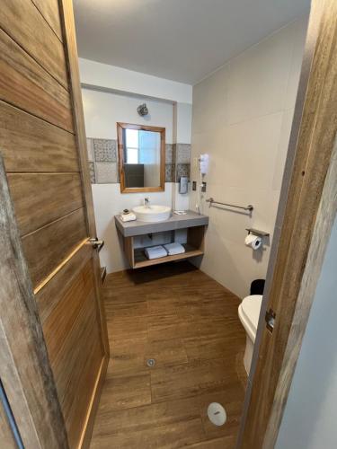 a bathroom with a sink and a toilet and a mirror at CASA CRISTOBAL Centenario in Cusco