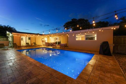 a swimming pool in a backyard at night at 3BR HEATED POOL CLOSE TO BEACH in Boynton Beach