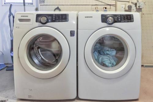 two washing machines are sitting next to each other at 3BR HEATED POOL CLOSE TO BEACH in Boynton Beach