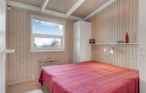 a bedroom with a pink bed with a window at 4 Bedroom Lovely Home In Hundested in Hundested